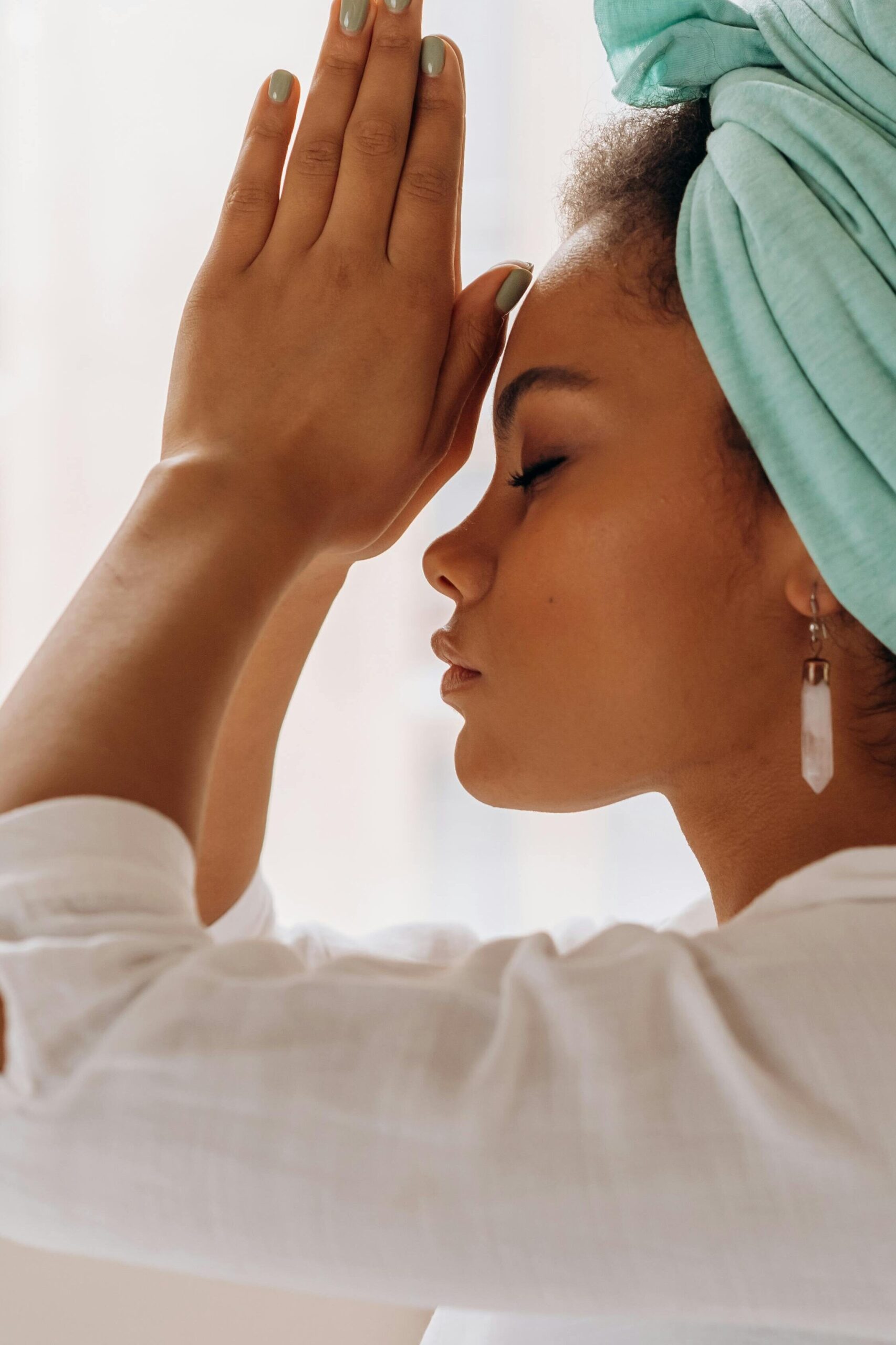 Woman practicing meditation indoors with a focus on relaxation and mindfulness.
